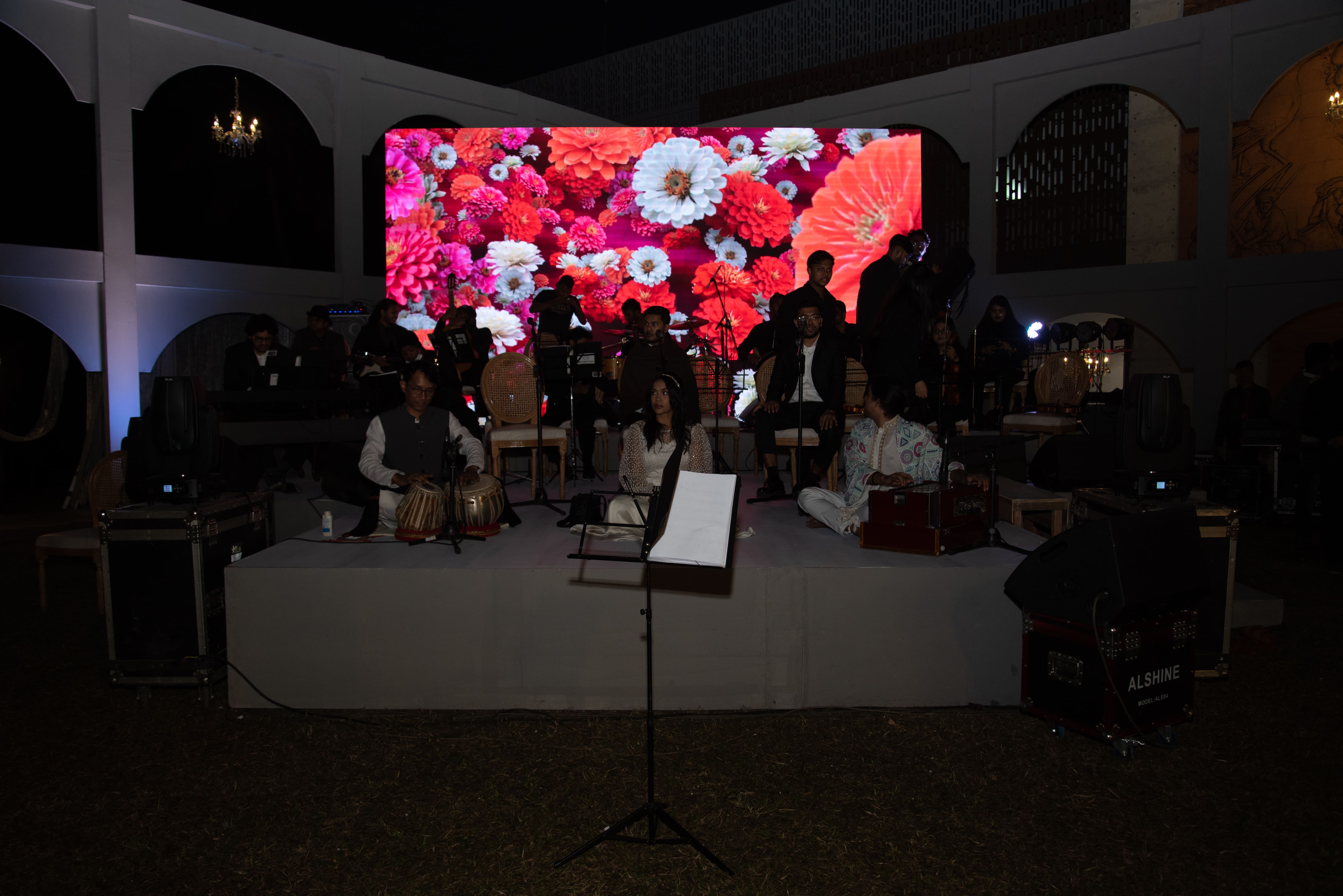 Musicians preparing for a live performance, where collective rehearsal practice transforms into shared musical expression on stage.