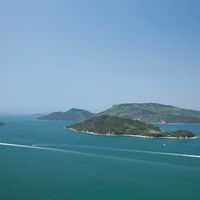 Image of small islands in japan with blue sea and boats